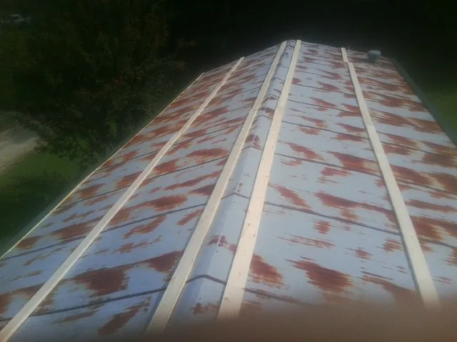 Rusted metal roof panels with new wood purlins before replacement — Storm Damage Roof Repair in Saint John by Roofing Brothers
